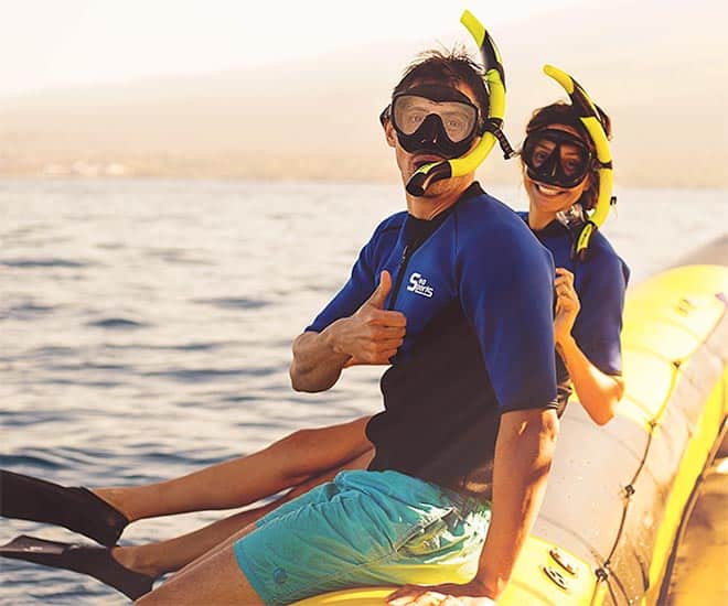 happy snorkelers sitting on the boat at sunset