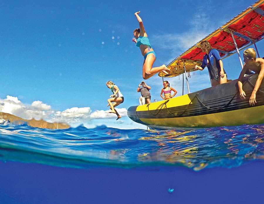 Guest jumping off of the boat into the water